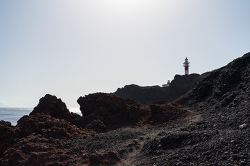 Lighthouse on the rocky shore of the Atlantic Ocean. Cape Teno (Punta de Teno). Tenerife. Canary Islands. Spain.