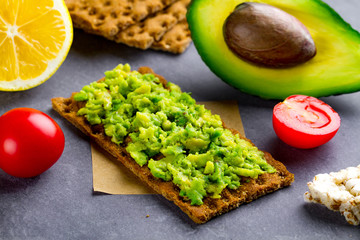 Avocado sandwich with avocado cream and rye crisp bread for snack. Fiber, fitness and diet food.