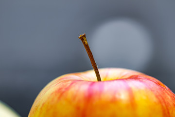 Red-yellow, juicy apple close up. Healthy food, eating fresh fruit