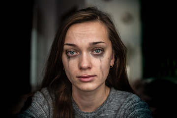 Portrait of a crying, sad, depressed woman because of problems at work and troubles in relationships. Woman violence and depression concept. Social and life problems - obrazy, fototapety, plakaty