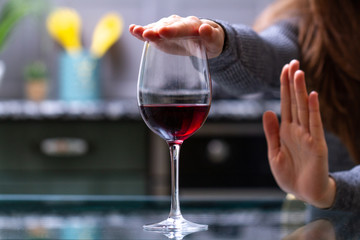 Woman refuses to drink a alcohol. Female alcoholism concept. Treatment of alcohol addiction. Quit booze and alcoholism.