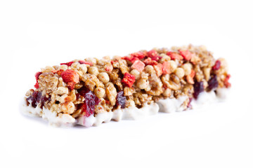 Isolated Muesli and Granola bar. Healthy, fitness, sweet dessert snack and fiber food. Cereal granola bar with fruit and berries on a white background