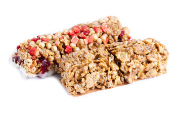 Isolated Muesli and Granola bar. Healthy, fitness, sweet dessert snack and fiber food. Cereal granola bar with fruit and berries on a white background