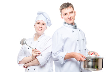 horizontal portrait of a pair of cooks with a pan and a ladle on a white background