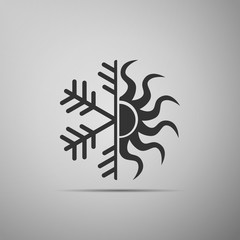 Hot and cold symbol. Sun and snowflake icon isolated on grey background. Winter and summer symbol. Flat design. Vector Illustration