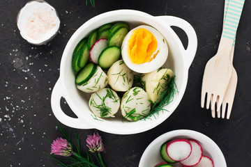 Potato salad with dill and boiled egg .. On a dark background. Top view.