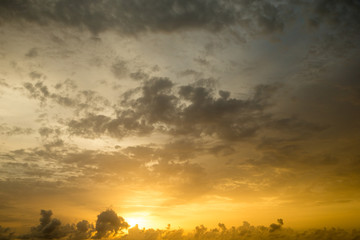 Sunset with sun rays, sky with clouds and sun.