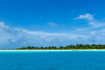 tropical Maldives island with white sandy beach and sea