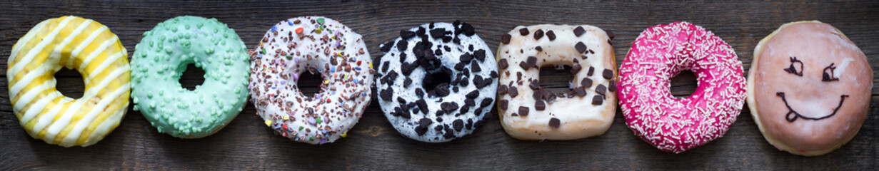 Doughnuts donuts various types of cakes abstract fat thursday banner layout concept