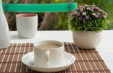 coffee cup on wood table in the morning and garden