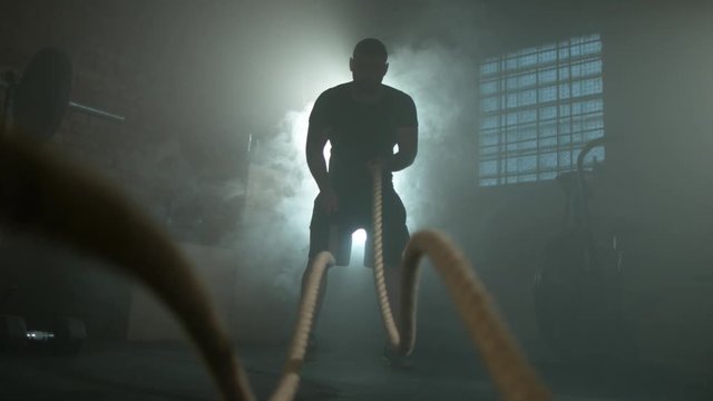 Super slow motion of young man doing exercise with rope, filmed on high speed cinema camera, 1000fps.