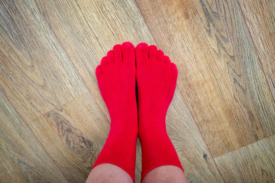 Feet in red finger socks