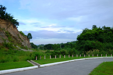 Curve country road with barrier pole on the hill at mountain pass