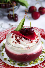 Creamy cherry dessert with pistaccio close up
