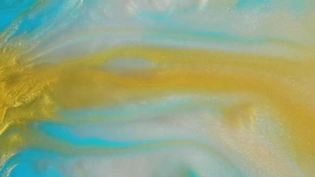 Colorful golden sand organically moves in colorful liquid
