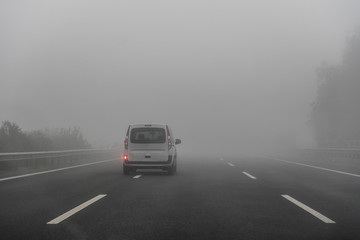 Fototapeta na wymiar Car Moving in the Fog