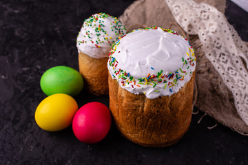 Easter, cake, eggs, holiday. Easter cake and colorful eggs on a dark background. Itcan be used as a background