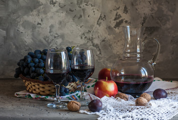 two glasses of wine with fresh grapes