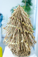 Homemade tree made of twigs, decorated with cones and beads
