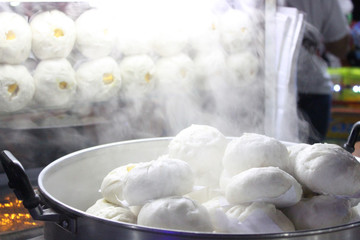 closeup hot streaming bun in pot with smoke