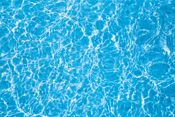 Obraz premium Blue ripped water in swimming pool with sunny reflections.