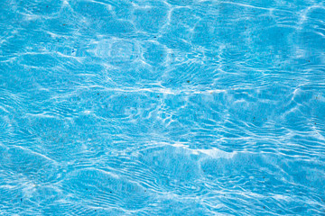 Obraz premium Blue ripped water in swimming pool with sunny reflections.