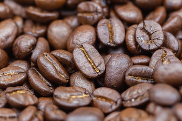 Brown roasted coffee beans. Closeup shot of coffee beans. Coffee beans can be used as a background.