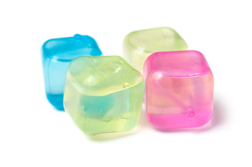 closeup of colorful plastic ice cubes on white background
