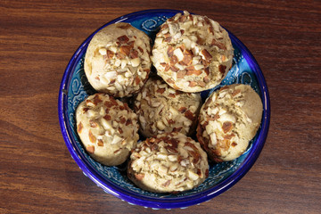 Traditional oriental ginger cookies on the wooden table.  Gingerbread with nuts, almonds, sage and saffron.