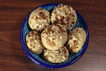 Traditional oriental ginger cookies on the wooden table.  Gingerbread with nuts, almonds, sage and saffron.