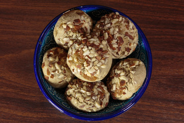 Traditional oriental ginger cookies on the wooden table.  Gingerbread with nuts, almonds, sage and saffron.