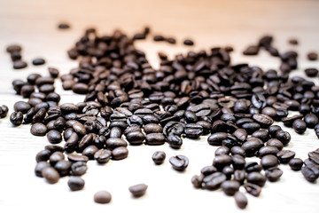 Coffee beans are placed in containers and spread on the background of wood grain.
