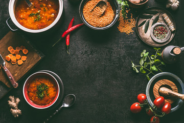 Lentil dishes food background. Lentil soup with cooking ingredients on dark rustic kitchen table...