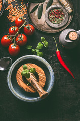 Healthy vegetarian ingredients for tasty cooking and eating on dark kitchen table background, top view