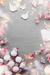 Easter background frame with egg-crate and Easter decoration accessories, spring blossom on gray background, top view, flat lay. Copy space for your design