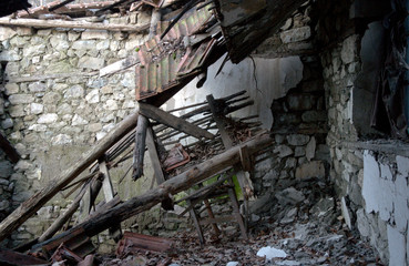 Collapsed wooden roof of old stone building