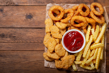 fast food products: onion rings, french fries and chicken nuggets
