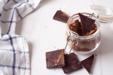 with cocoa and dark chocolate on a white background.