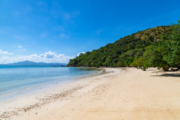 Fototapeta na wymiar Amazing tropical beach on the Bulalacao island. Beautiful tropical island with white sand and palm trees. Palawan, Philippines.