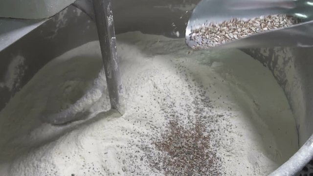 Add the seed mixture to the dough. slow motion