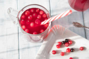 a useful vitamin drink from cranberry, chokeberry, black currant, pear and apple on the wooden table