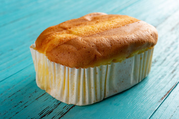 side view cup cake on blue wood background