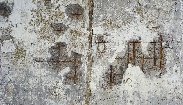 abstract texture of a destroyed wall with rusty fittings