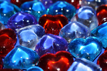 Colorful decorative stones in the shape of a heart. Glass ornaments close-up.
