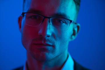 The portrait of the handsome businessman in glasses