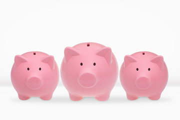 Three ceramic piggy banks on a white background