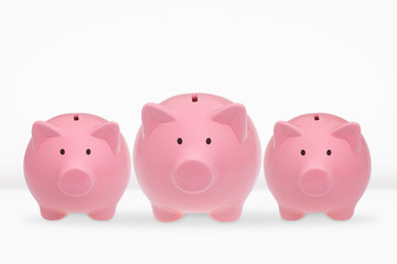 Three ceramic piggy banks on a white background