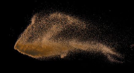 Fototapeta na wymiar Sandy explosion isolated on over dark background,Abstract sand cloud,Motion blur