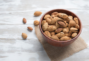 Almonds in a bowl on the wood table