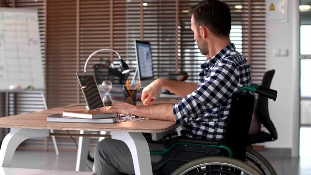 Side view of man using laptop in office
